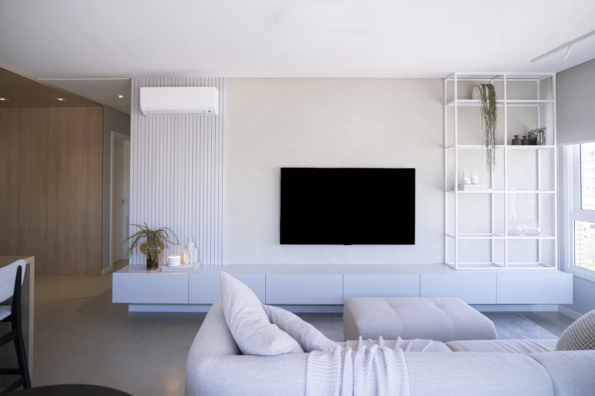 LG style LED TV mounted in a modern white living room