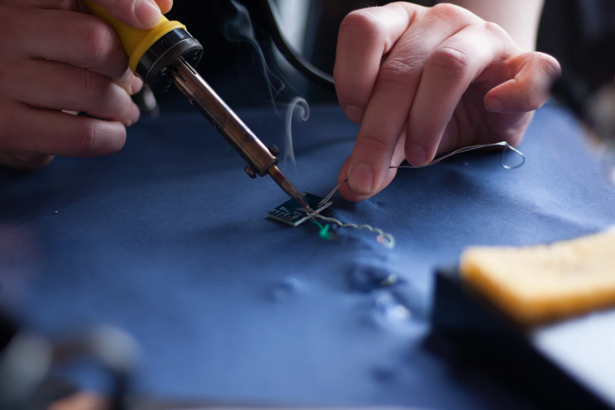 Close-up of soldering a component on a TV board